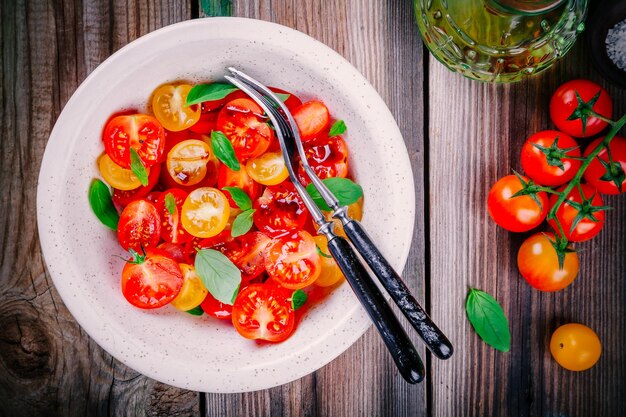 Bright salad of organic cherry tomatoes with basil balsamic and olive oil