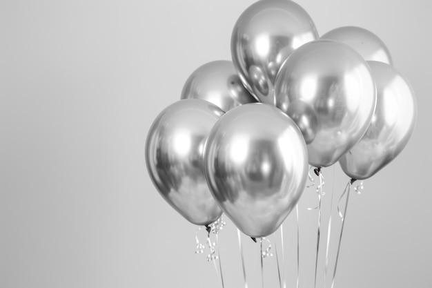 Bright Silver Balloons on White Background Celebration and Birthday Concept