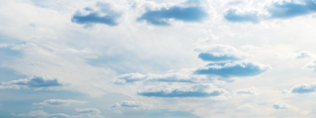 Bright sky with small fluffy clouds illuminated by the sun