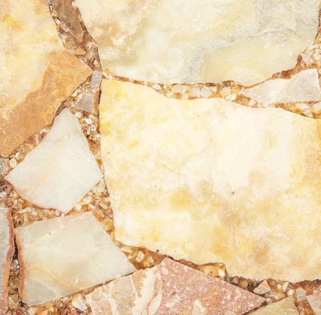 Bright stone background from compressed marble fragments