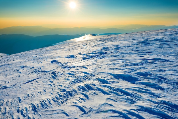 Bright sun in winter mountains covered with snow