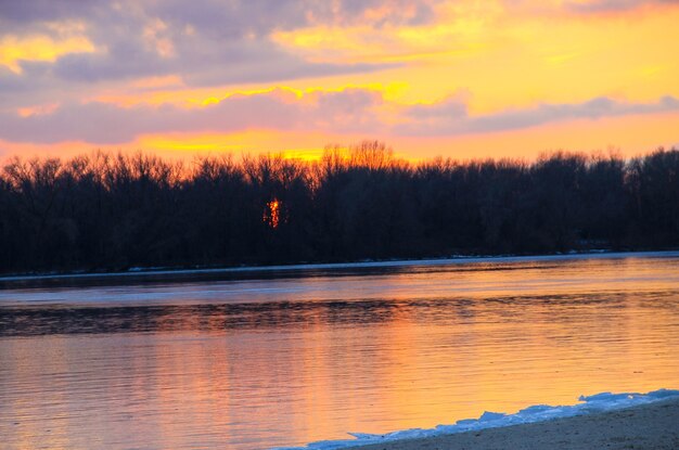 Bright sunset over the river Dnieper on winter