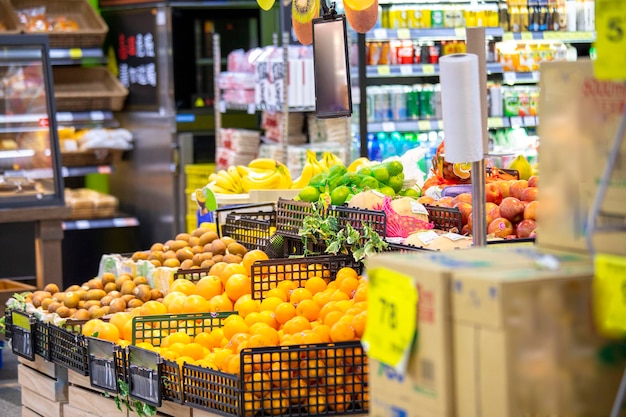 A bright supermarket in the community, displaying a wide range of fruits and vegetables and goods