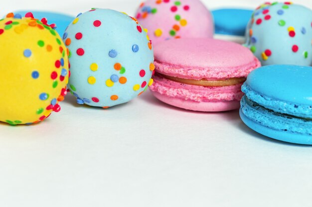 Bright tasty macaroons and cake pops of blue and pink 