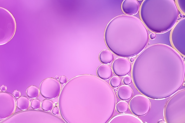 Bright and unique oil drops, circles on the water surface. Unusual background. Colorful wallpaper of  bublles