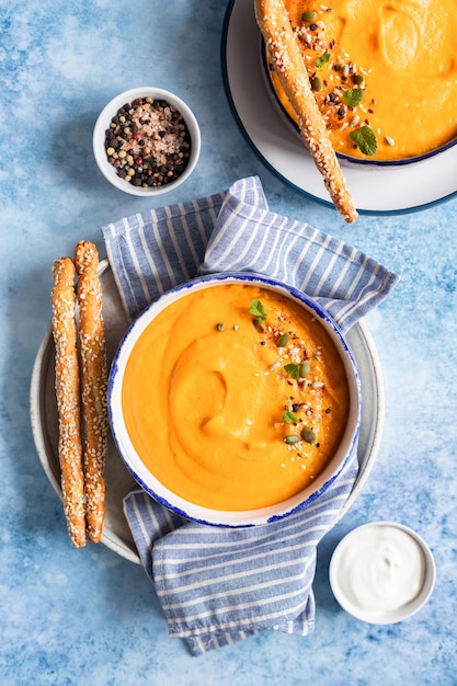 Bright vegetarian autumn pumpkin and carrot soup Comfort food fall and winter slow food concept