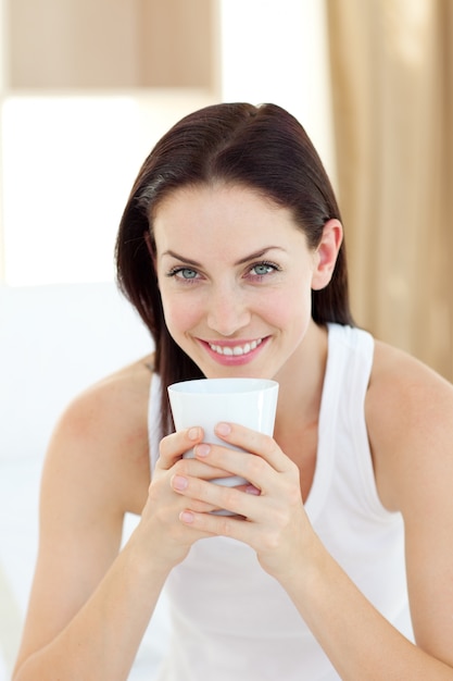 Bright woman drinking a coffee 