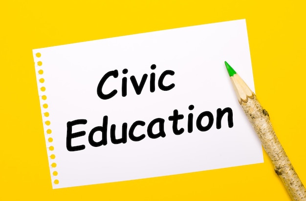 On a bright yellow background, a large wooden pencil and a white sheet of paper with the text CIVIC EDUCATION