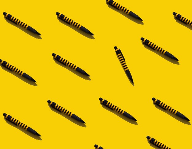 Bright yellow background with pens