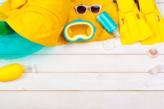 Bright yellow flippers and diving mask on a vibrant