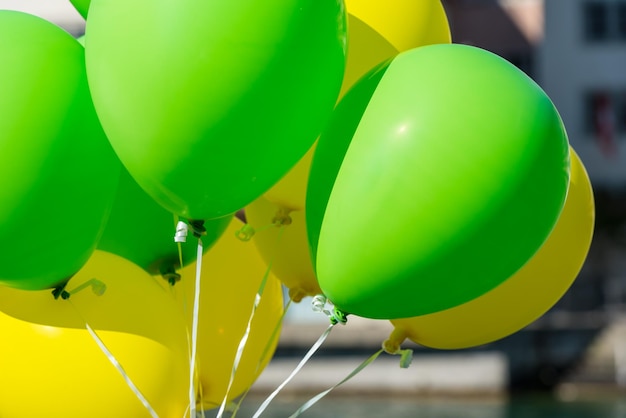 Bright yellow and green balloons on a city street