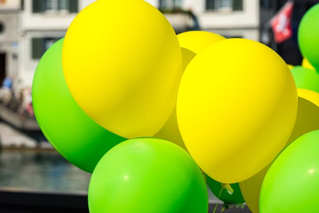 Bright yellow and green balloons on a city street