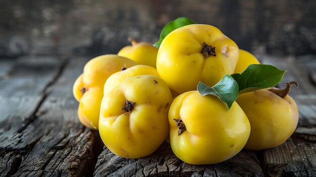 Photo bright yellow quinces with green leaves on a rustic wood surface showcasing fresh autumn fruit