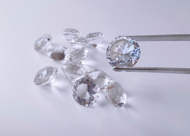 Brilliant cut diamond held by tweezers