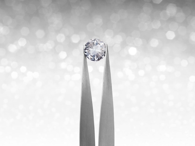 Photo brillliant round diamond in tweezer on white shining bokeh background concept for chossing best diamond gem design