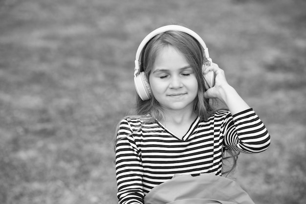 Bring music to life Little child listen to music with closed eyes Small girl wear headphones playing music New technology Modern life Fun and entertainment Press play and enjoy copy space