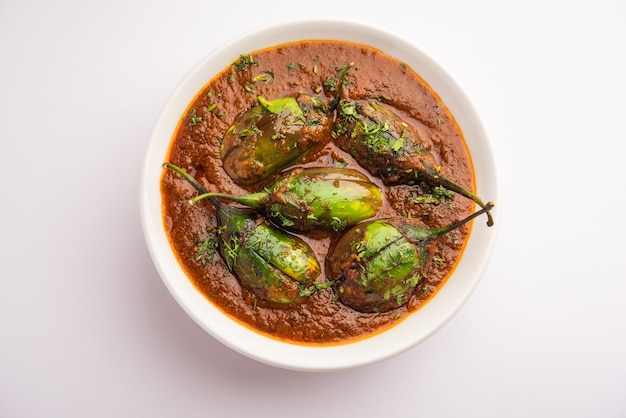 Brinjal curry also known as spicy baingan or eggplant masala, a popular main course recipe from India served in a bowl, karahi or pan