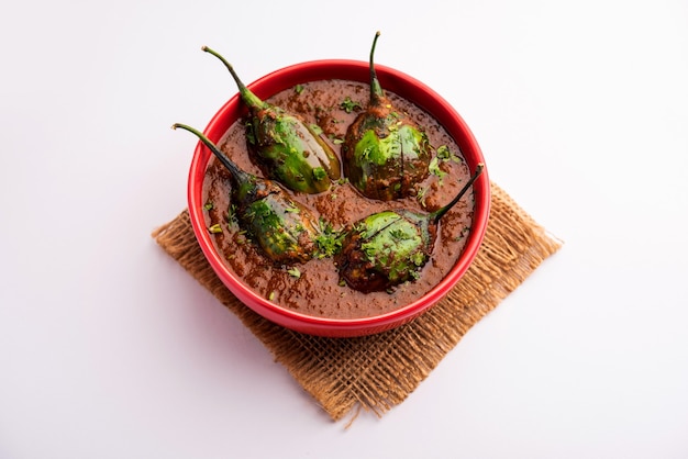 Brinjal curry also known as spicy baingan or eggplant masala, a popular main course recipe from India served in a bowl, karahi or pan