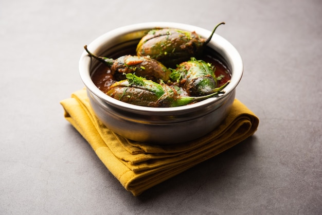 Brinjal curry also known as spicy baingan or eggplant masala, a popular main course recipe from India served in a bowl, karahi or pan