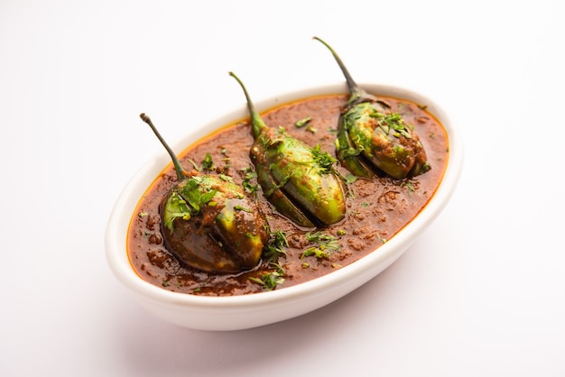 Brinjal curry also known as spicy baingan or eggplant masala, a popular main course recipe from India served in a bowl, karahi or pan