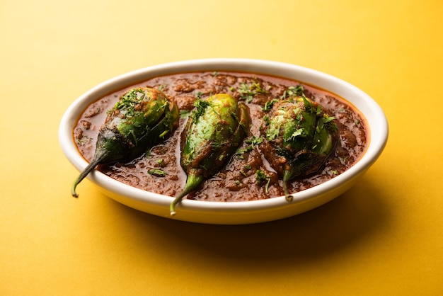 Brinjal curry also known as spicy baingan or eggplant masala, a popular main course recipe from India served in a bowl, karahi or pan