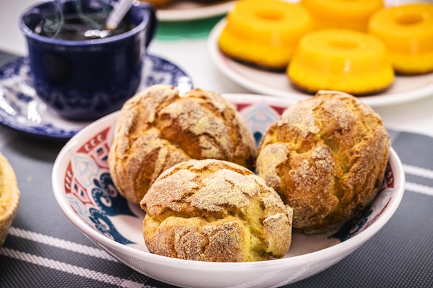 Broa traditional portuguese corn bread made with corn and wheat flour and typical portuguese sweets in the background european breakfast