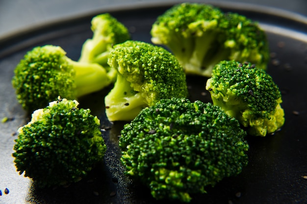 Broccoli on a black plate. 