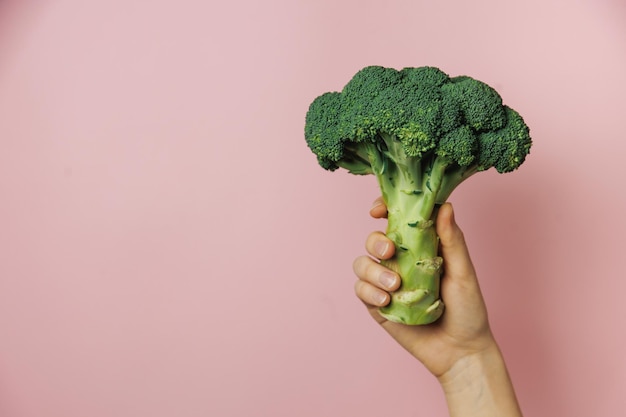 broccoli in hand vegetarian concept healthy food