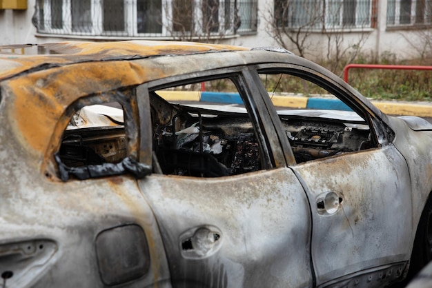 Broken and burnt car in the parking lot, accident concept