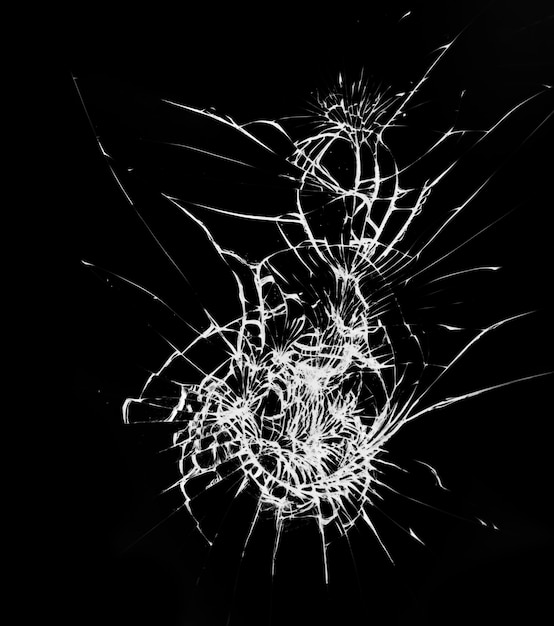 Broken glass with cracks on black background Blow on the protective glass of the smartphone