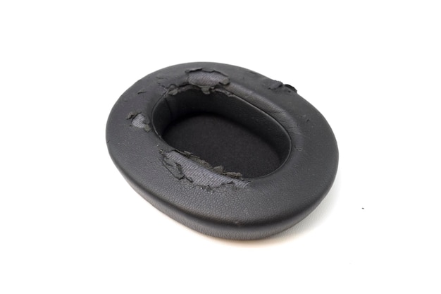 Broken headphone pad from frequent use isolated on a white background