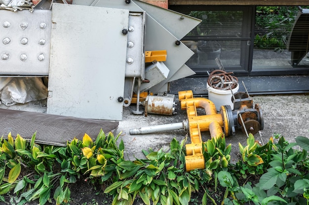 Broken parts of the equipment were thrown into a pile of construction debris