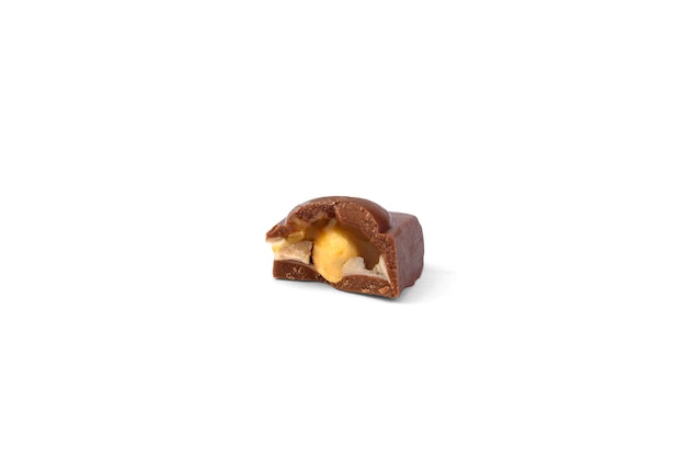 Photo broken piece of milk chocolate with caramel and nut on a white background