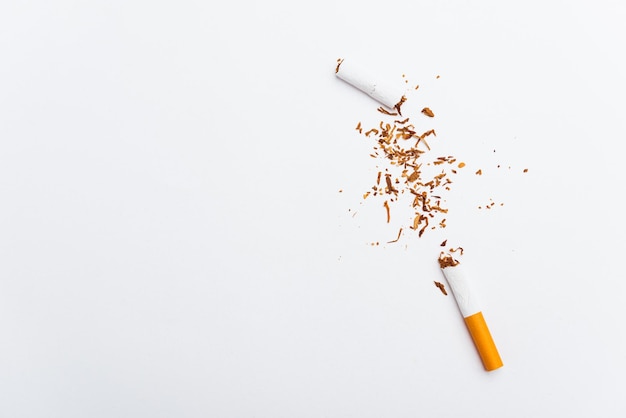 Broken pile cigarette or tobacco on white background