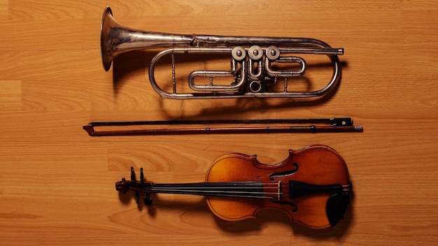 Broken trumpet and violin on the wooden floor