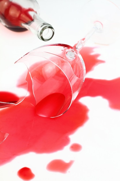 Broken wine glass and spilled red wine