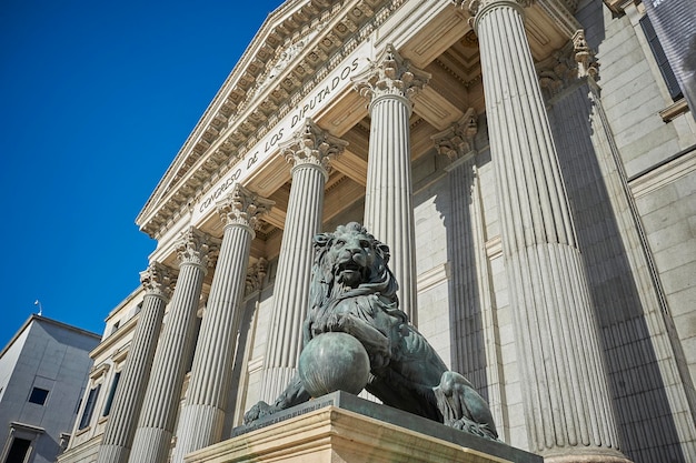 Bronze lions on the famous faÃÂ§ade of the Spanish Parliament Building, Madrid (Spain)