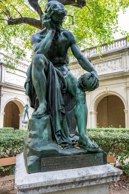 Bronze sculpture of man with skull