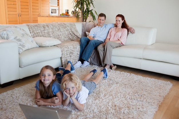 Brother and sister with notebook on the carpet