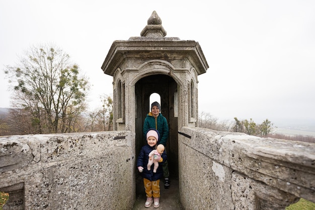 Brother with sister visit Pidhirtsi Castle Lviv region Ukraine Family tourist