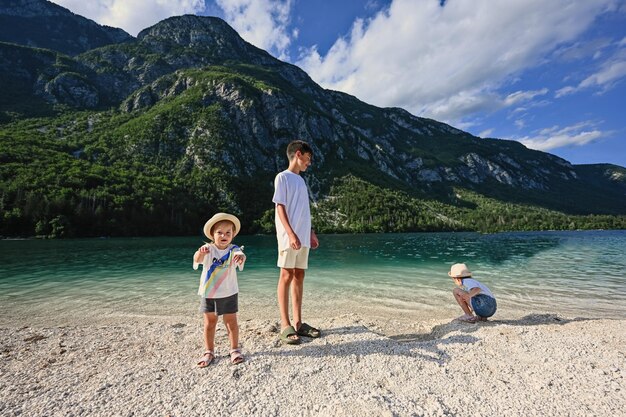 Brother with sisters in Lake Bohinj the largest lake in Slovenia part of Triglav National Park