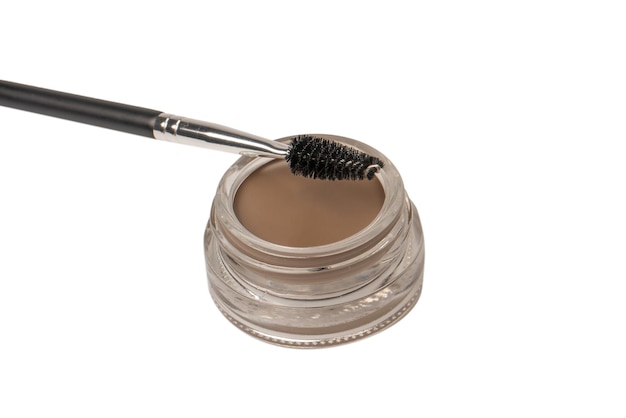 A brow pomade in blonde shade with brush isolated on a white background