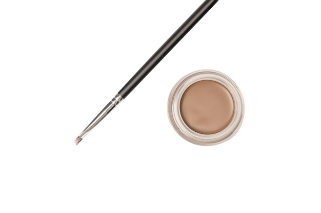 A brow pomade in blonde shade with brush isolated on a white background