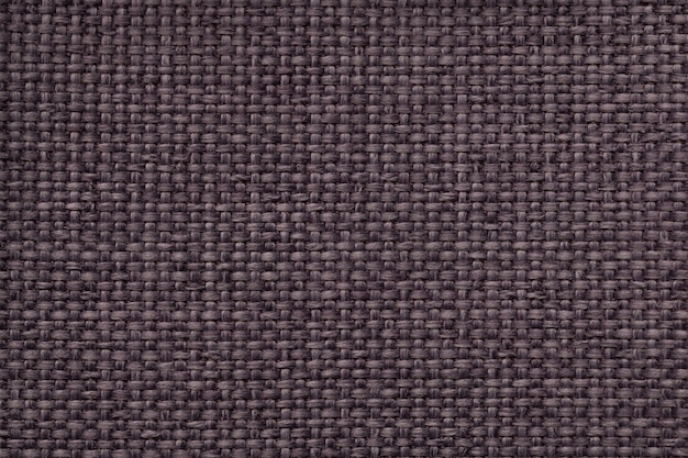 Brown background with braided checkered pattern, closeup. Texture of the weaving fabric, macro.