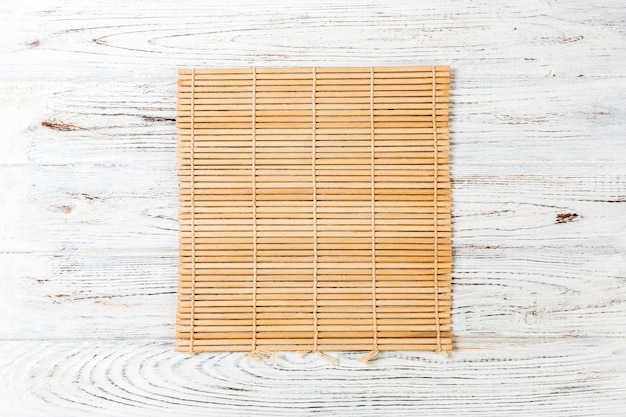 Brown Bamboo mat on white wooden