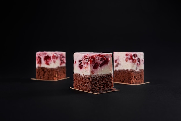 Brown biscuit and cherry mousse cake slices.