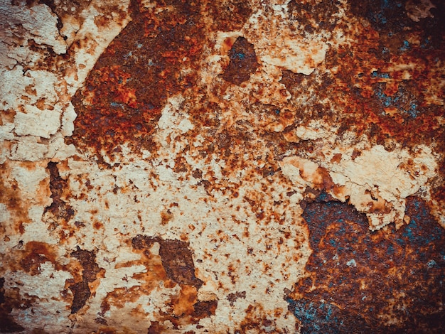 Brown, black and orange rust and dirt on white enamel