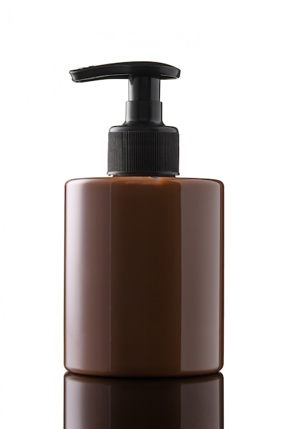 Brown bottle of liquid soap or gel on a white isolated background. Chocolate bottle of intimate soap on a glass surface.