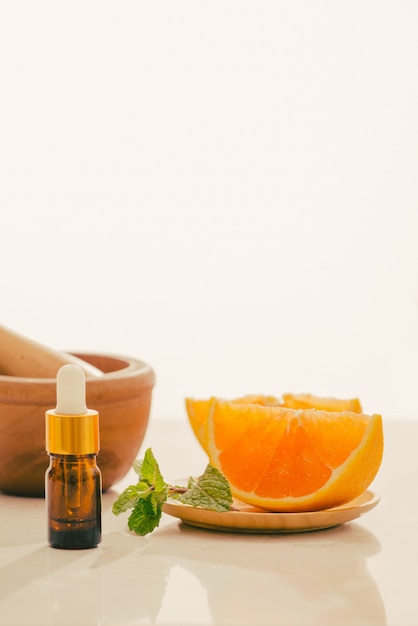 Brown Bottle with lemon, orange, tangerine and vitamin C. on white background.