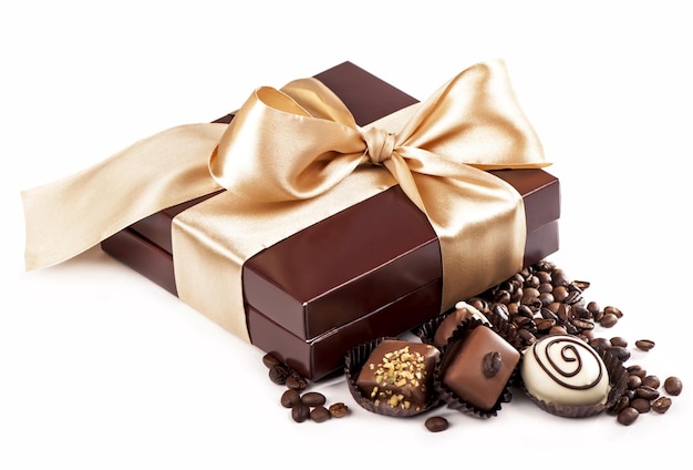 Brown box with candies and golden tape coffee grains